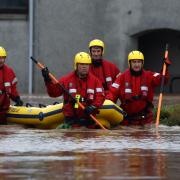 Emergency workers wade through flooding in Brechin, Angus
