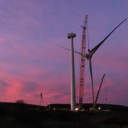 Blades are lifted onto a turbine at the consumer-owned Kirk Hill wind farm in Ayrshire