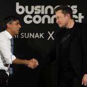 British Prime Minister Rishi Sunak (L) shakes hands with Tesla and SpaceX CEO Elon Musk after an in-conversation event