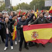 People protest against the investiture debate a day before the Socialist leader seeks the endorsement of the chamber to form a new government at the nearby Spanish Parliament in Madrid Spain, Wednesday, Nov. 15, 2023. Demonstrators are protesting