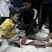 A Palestinian boy wounded in Israeli airstrikes on a U.N.-run school receives treatment at the Nasser hospital in the town of Khan Younis, southern Gaza Strip. Saturday, Dec. 17, 2023. (AP Photo/Mohammed Dahman).