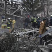 People clear the debris at the site of Russia's air attack in Zaporizhzhia