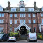 A far-right activist posed as an inspector to obtain information about a Dumfries hotel