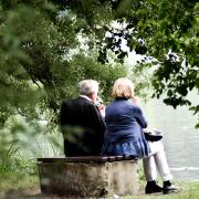 An elderly couple sit by a river. A wellbeing economy would address quality life in older age, Gordon MacIntyre-Kemp argues
