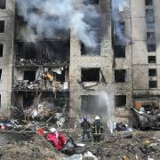Firefighters work to extinguish a fire in a destroyed apartment building after a Russian attack in Kyiv