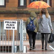 Voters arrive at a polling station in Glasgow