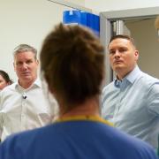 Keir Starmer (left) and Wes Streeting talk to NHS workers