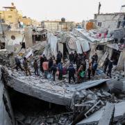 People inspect the damage to their homes following Israeli air strikes in Rafah, Gaza
