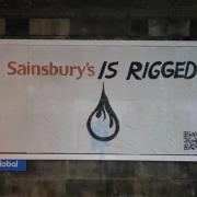 Campaigners replaced billboards across Glasgow to take aim at Sainsbury's