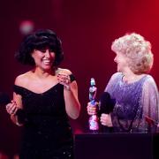 Raye on stage with Jo Hamilton after winning the award for Song of the Year