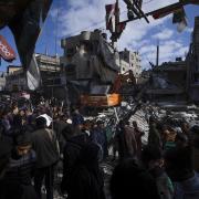 Palestinians check destruction after an Israeli strike in Rafah, Gaza Strip on Monday