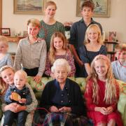 An image posted by Kensington Palace of the late Queen and her grandchildren has been edited