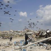 Humanitarian aid is airdropped to Palestinians over Gaza City