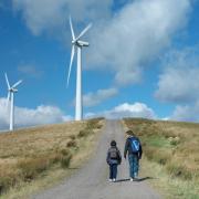 Two brothers walking on path at windfarm in Scotland