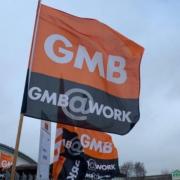 A GMB flag held by a protestor