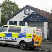 Forensics officers were seen going into a branch of A Milne Funeral Directors in Springburn