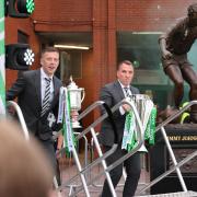 Celtic's Callum McGregor (left) with the Scottish Gas Scottish Cup and Celtic manager Brendan Rodgers with the cinch Premiership trophy during a trophy celebration at Celtic Park, Glasgow.