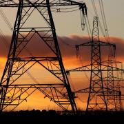 Electricity pylons pictured at sunset