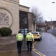 File photograph of two police officers outside Glasgow High Court