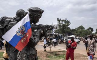 A Russian flag hangs on the monument of the Russian instructors in Bangui, during a march in 2022 in support of Russia and China's presence in the Central African Republic