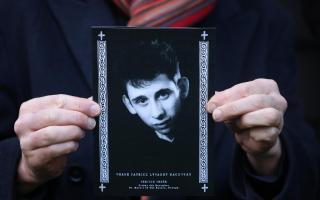 A mourner holds the order of service for the funeral of Shane MacGowan at Saint Mary's of the Rosary Church, Nenagh, Co. Tipperary.