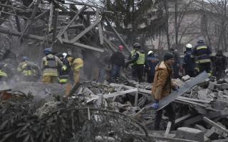 People clear the debris at the site of Russia's air attack in Zaporizhzhia