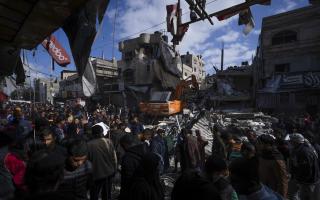 Palestinians check destruction after an Israeli strike in Rafah, Gaza Strip on Monday