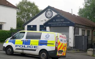 Forensics officers were seen going into a branch of A Milne Funeral Directors in Springburn