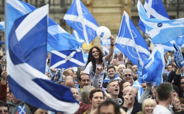 The National: Campaigners wave Scottish Saltires at a 'Yes' campaign rally in Glasgow, Scotland September 17, 2014. The referendum on Scottish independence will take place on September 18, when Scotland will vote whether or not to end the 307-year-old union with the re