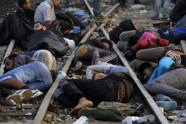Refugees sleep on railway tracks close to the border between Greece and Macedonia