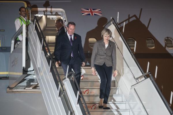 Theresa May and Liam Fox arrive at New Delhi airport yesterday ahead of trade discussions