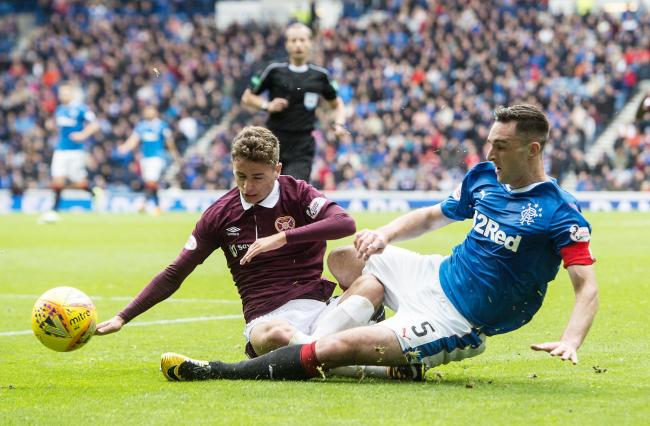 Rangers' Lee Wallace, right, competes with Jamie Brandon of Hearts. Photograph: SNS
