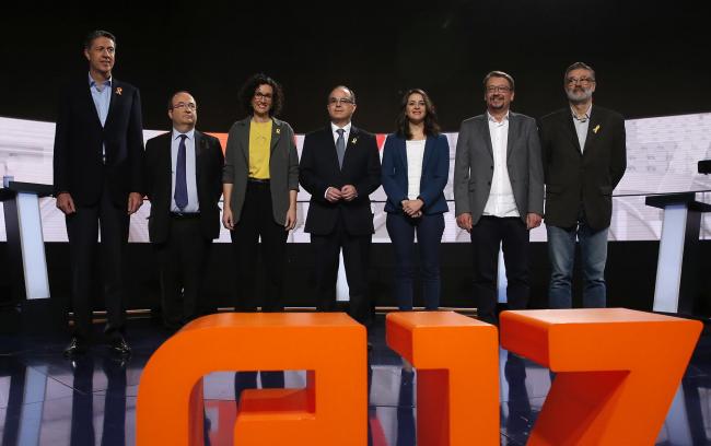 Catalan parties' candidates pose for photographers on Monday, Dec. 18, 2017 in Barcelona at the beginning of the last electoral television debate ahead of Thursday's regional election. (AP Photo/Manu Fernandez).