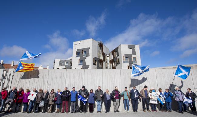 Thousands of people formed a human chain around the Scottish Parliament at the Hands off our Parliament (HOOP) demonstration