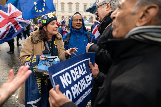 Anti-Brexit Remain campaigners, left, debate with pro-Brexit Leave campaigners