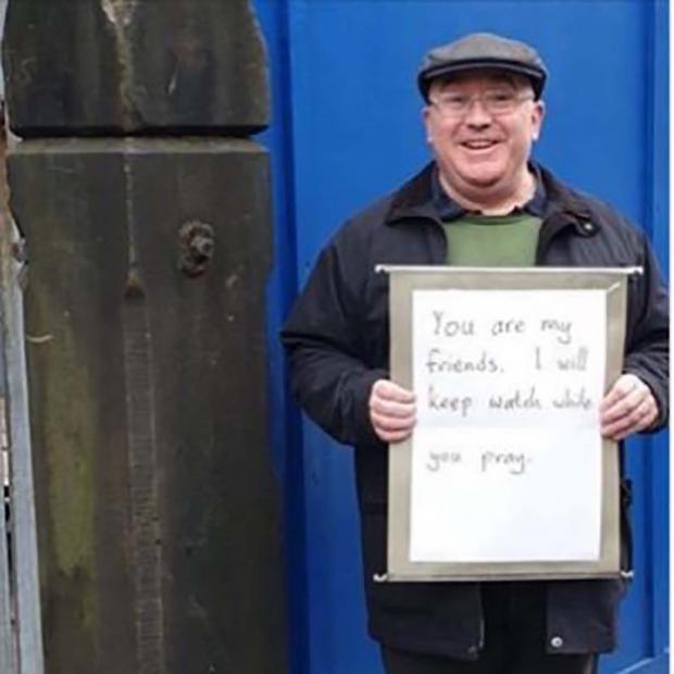 The National: An image of Andrew Graystone outside a mosque with a message of solidarity went viral